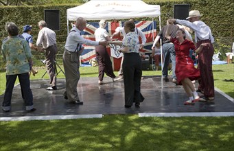 People performing dances to 1940s swing music during a country fair, Helmingham Hall, Suffolk,