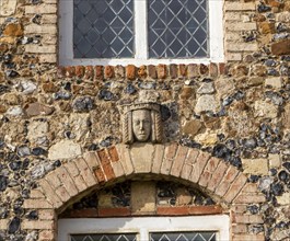 Carved face and head of Tudor female figure, Framlingham castle, Suffolk, England, UK