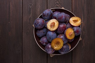 Blue plum, on a wooden table, top view, close-up, no people