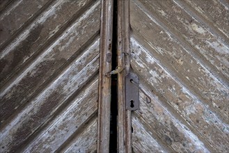 An old, rusty door with a padlock and clear signs of use, Istria, Croatia, Europe