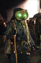 Carnival figure with military-style costume and mask with glowing green eyes, carnival, Schellbronn