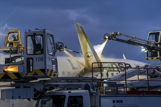 Winter at Frankfurt Main Airport, FRA, Lufthansa aircraft being de-iced by de-icing vehicles,