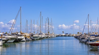 Luxury yachts anchored in the harbour of Santa Eularia des Rui, Ibiza, Balearic Islands,