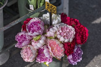 Colourful fabric flowers at a flower stand in front of the cemetery, Genoa, Italy, Europe