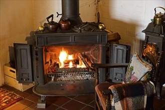 Europe, Germany, fireplace, stove, type Franklin, in living room, chair by the fireplace, Hamburg,