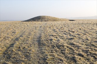 Bronze Age bowl barrow on Windmill Hill, a Neolithic causewayed enclosure, near Avebury, Wiltshire,