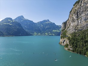 Lake Uri, part of Lake Lucerne near Flüelen, windsurfers in front of the mountains of the Alps.