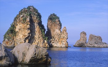 Limestone rock stacks stand in blue Tyrrhenian sea, Scopello, Sicily, Italy, Europe