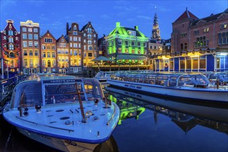 Canal houses on the Damrak, in the centre of the old town of Amsterdam, harbour, starting point of