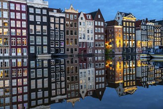 Canal houses on the Damrak, in the centre of the old town of Amsterdam, harbour, starting point of