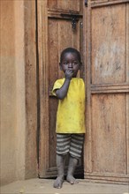 South Ethiopia, Ari people, little boy standing in the front door, Ethiopia, Africa