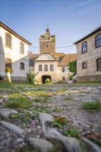 Medieval castle courtyard with stone paths and historic buildings in the sunlight, Harz Mountains,