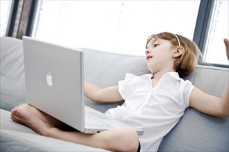 A little girl with a laptop is tired, Studio