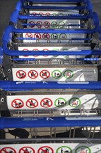 Close up of line of stacked luggage trolleys with rules about use, Malaga airport, Spain, Europe