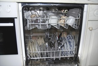 Dishwasher, open with crockery