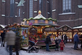 Europe, Germany, Hamburg, Christmas market in front of St Peter's Church, Children's carousel,