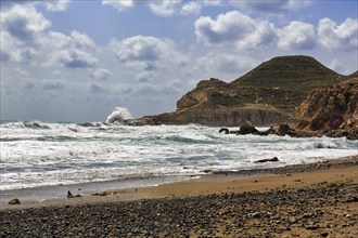 Surf on a pebble beach, rocky coast, Cabo de Gata Natural Park, Las Negras, Almeria, Andalusia,