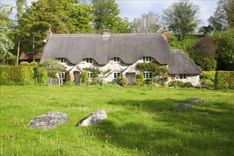 Two historic semi-detached thatched cottages at Lockeridge village, Wiltshire, England, United