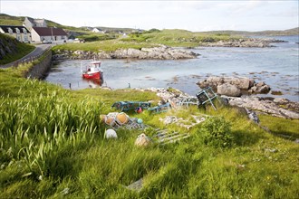 Small fishing boat at moorings on the east coast of Barra, Outer Hebrides, Scotland, UK