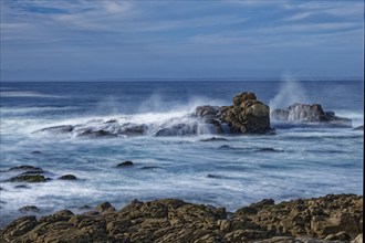 The waves of the Atlantic wash over the rocks on the coast off Penmarch in Brittany. Finistere,