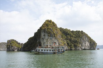 Excursion boat and the karst rocks in Lan Ha Bay, Halong Bay, Vietnam, Asia