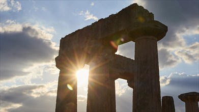 Archaic Temple of Apollo, Doric columns, Sunset behind ancient ruins with shining columns,