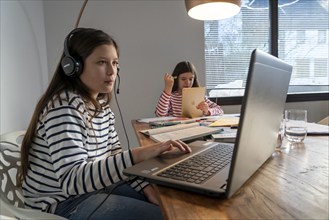 Homeschooling, during the lockdown in January 2021, children learning at home for school, a girl in