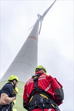 Height rescuers from the Oberhausen fire brigade practise abseiling from a wind turbine from a