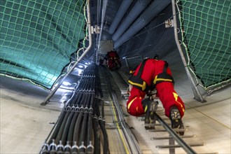 Height rescuers from the Oberhausen professional fire brigade practise abseiling from a wind