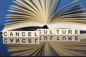 Symbolic image Cancel Culture: Letter cubes show the words Cancel Culture in front of a book