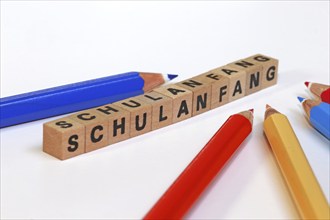 Symbolic image for the start of the new school year with letter cubes and pens