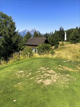 Golf Course with Mountain View and Peak Pilatus and the Moon in a Sunny Summer Day in Burgenstock,