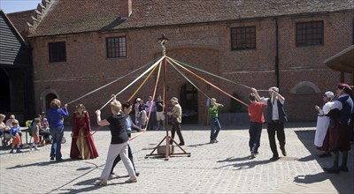 People maypole dancing during Tudor history re-enactment day, Layer Marney Tower, Essex, England,