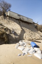 March 2018, Clifftop property collapsing due to coastal erosion after recent storm force winds,