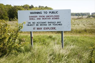 Ministry of Defence warning sign about the danger of unexploded shells and bombs on the firing