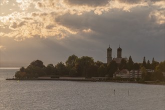 Baroque castle church, double tower, onion dome, evening light, sunbeams, Friedrichshafen on Lake