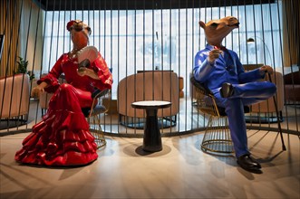 Interior view lobby, two camel figures waiting, sitting on chairs, Hotel NH Collection The Palm