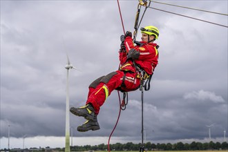 Height rescuers from the Oberhausen fire brigade practise abseiling from a wind turbine from a