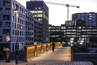 People walk over the Golda Meir footbridge in the Europacity Berlin development area on