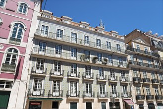 Building facades of an old town with multi-storey buildings and balconies under a clear sky, house