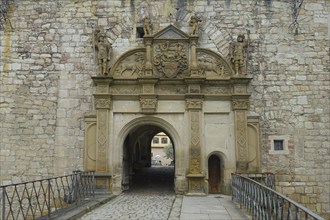 Portal, gate, round arch, bridge, cobblestones, stone figures, coat of arms, relief, decoration,