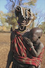 South Ethiopia, in Maco National Park, Mursi tribe, Mursi woman with baby, painted skin and