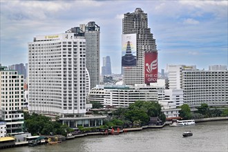 Shangri-La Hotel and Sathorn Unique Tower with iphone advert, Bangkok, Thailand, Asia