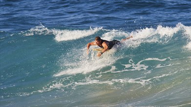 Surfer paddling on a powerful sea wave, wave surfer, surfer, surf, waves, west coast, Arkasa,