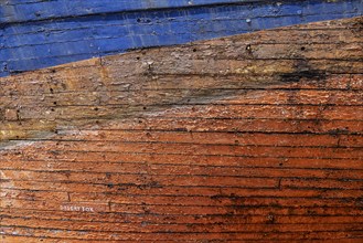 Colourful ship's planks, rotten hull and old planks of a ship, close-up of the underwater hull.