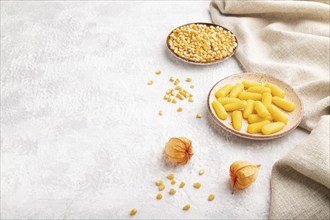 Jelly corn candies on gray concrete background and linen textile. side view, copy space