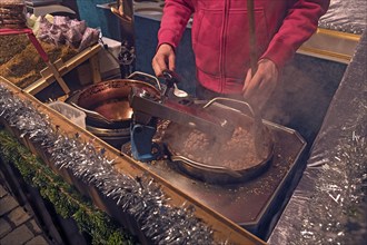 Preparation of roasted almonds at a stall at the Christkindlesmarkt, Nuremberg, Central Franconia,