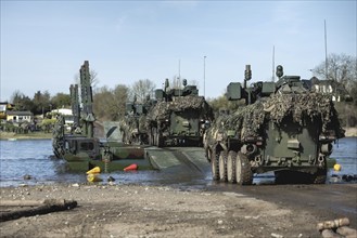 Pandur wheeled tanks of the Czech army drive onto German Bundeswehr vehicles of the Amphibie M3