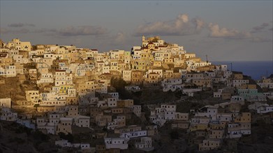 Town on a hill in the warm morning light with sea view, Colourful mountain village, Morning light,