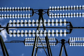 Insulators made of glass on a high-voltage line, they hang on the pylons as a suspension device